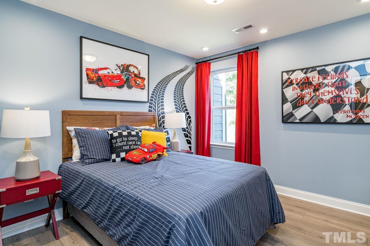 3107 Dunnock Drive, Unit 6 Durham, NC 27713 - Photo 23 of 27 a bedroom with a bed and painting on the wall