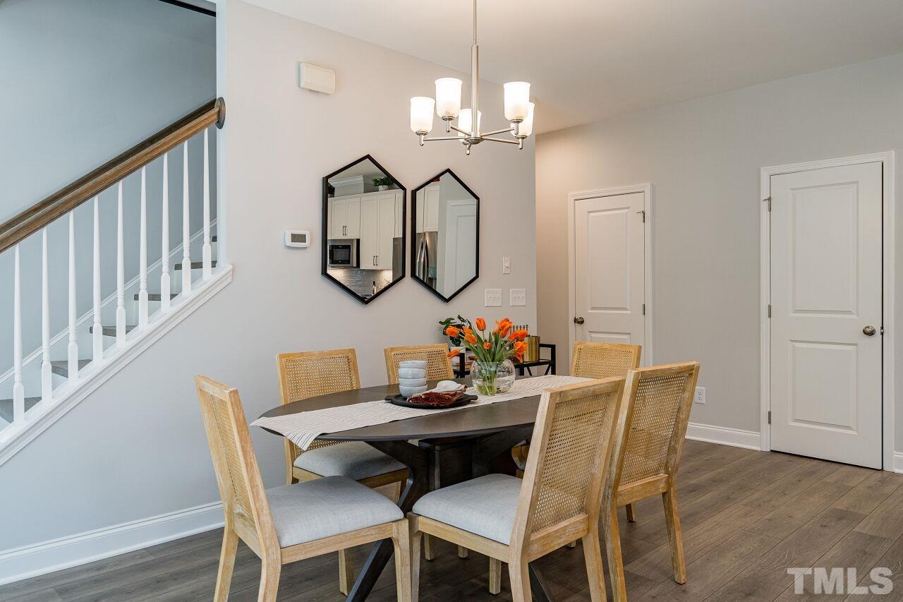 3107 Dunnock Drive, Unit 6 Durham, NC 27713 - Photo 9 of 27 a view of a dining room with furniture and wooden floor
