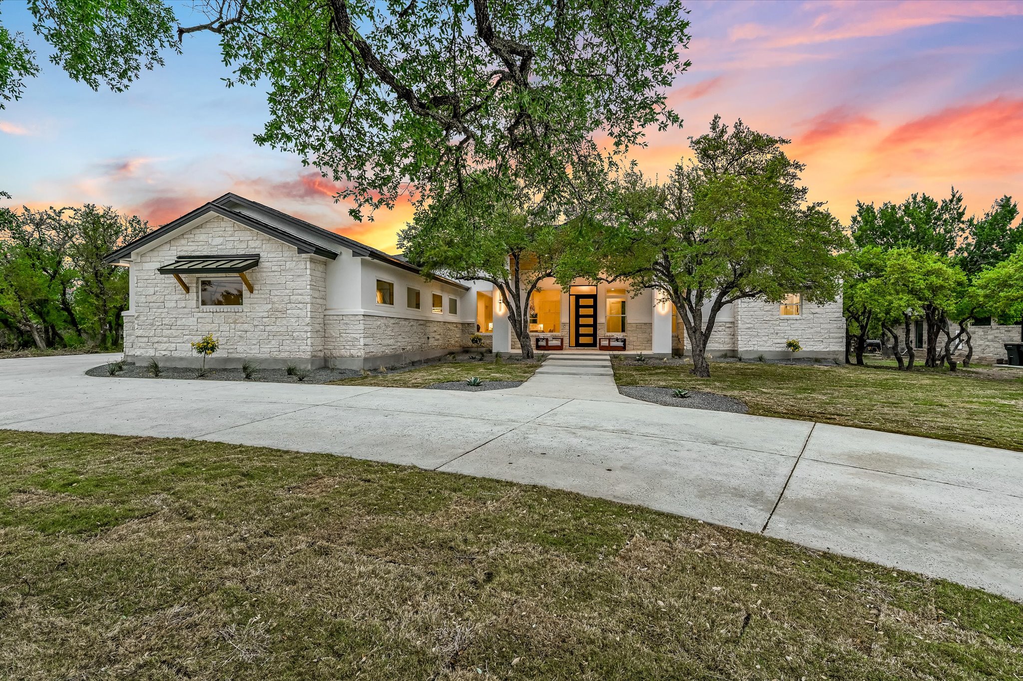 410 Shady Tree Drive Georgetown, TX 78633 - Photo 2 of 40 View of front facade featuring stone siding, a front lawn, and driveway