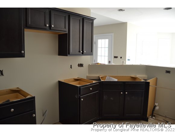 9628 Lukes Run Road Linden, NC 28356 - Photo 12 of 25 a kitchen with a sink and cabinets