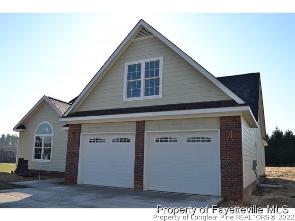 9628 Lukes Run Road Linden, NC 28356 - Photo 3 of 25 a front view of a house with a yard and garage