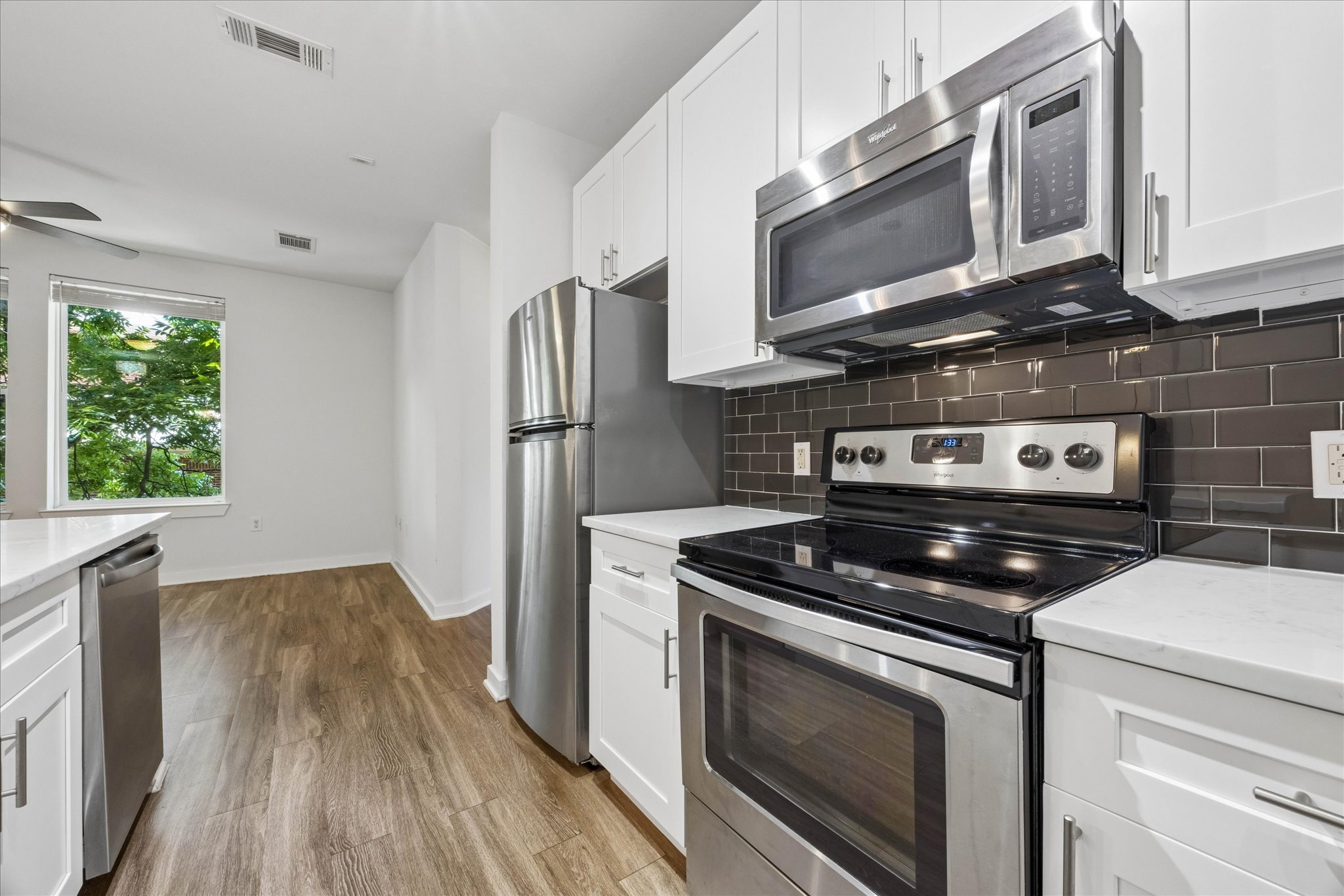 1900 Barton Springs Road, Unit 4041 Austin, TX 78704 - Photo 10 of 35 A well-equipped kitchen features sleek stainless steel appliances and durable hardwood flooring.