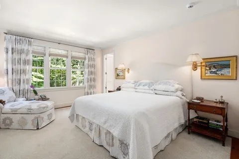 a front view of a house with a yard and trees