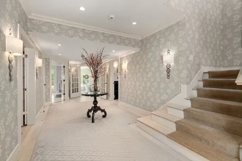 a view of entryway and hall with wooden floor