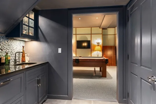 a front view of a house with a garden and trees