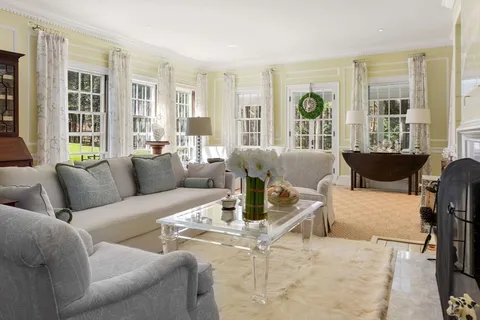 a view of a dining room with furniture and chandelier