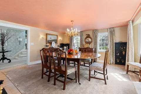 a view of a dining room and livingroom with furniture window and wooden floor