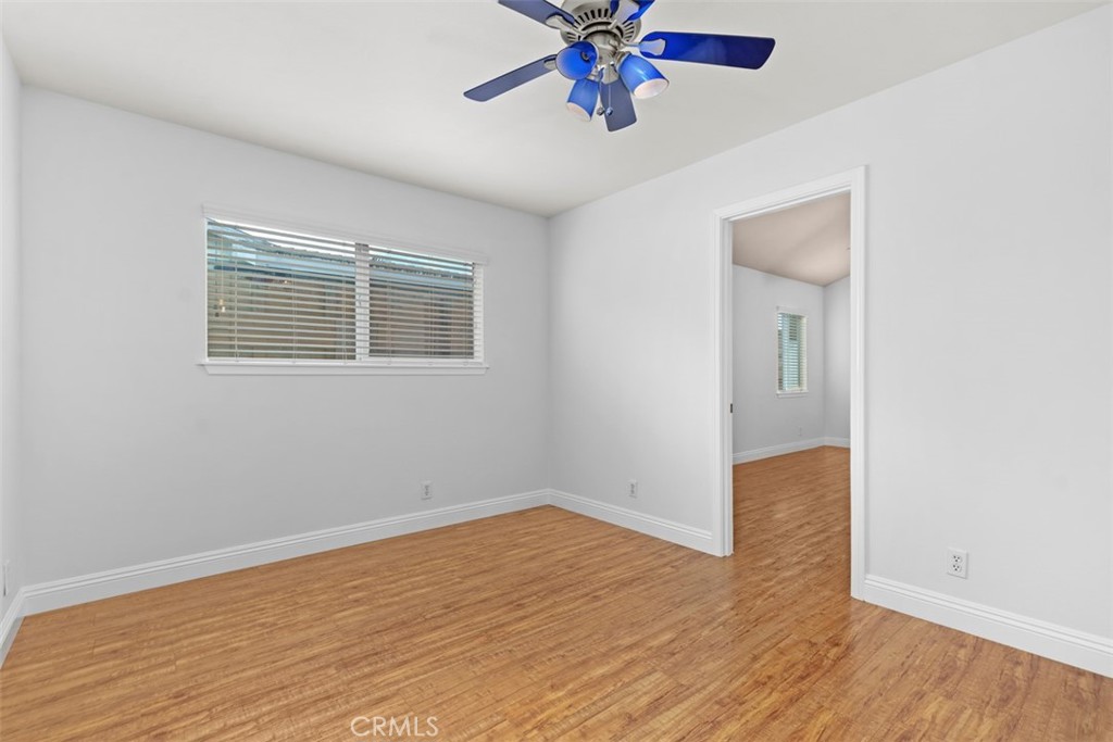 8792 Belday Street Cypress, CA 90630 - Photo 27 of 38 an empty room with wooden floor and windows