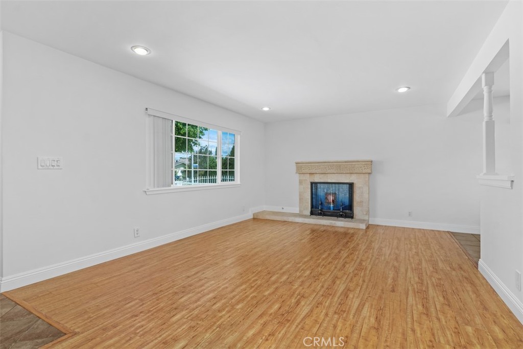 8792 Belday Street Cypress, CA 90630 - Photo 6 of 38 a view of an empty room with wooden floor and a window