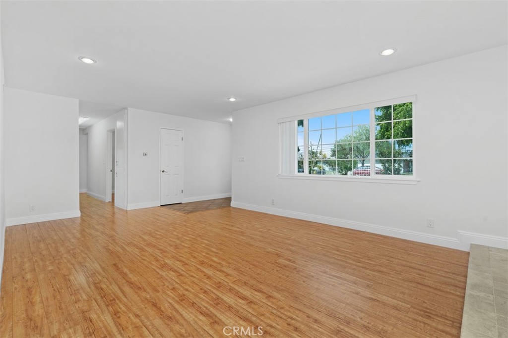 8792 Belday Street Cypress, CA 90630 - Photo 7 of 38 a view of an empty room with wooden floor and a window