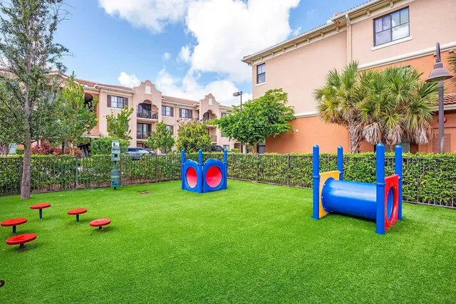 a view of a backyard with plants and palm trees