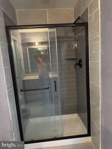 a bathroom with a glass shower door