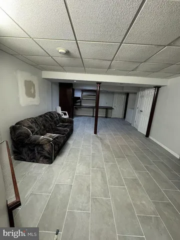 a view of a livingroom with furniture and an entryway