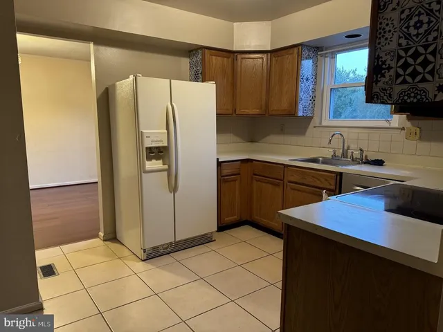 a kitchen with stainless steel appliances a refrigerator sink and cabinets