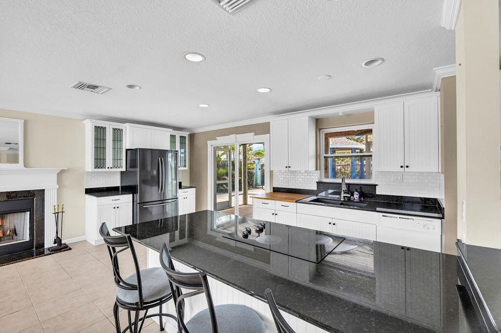 614 Southeast Flamingo Avenue Stuart, FL 34996 - Photo 12 of 49 a large white kitchen with sink and cabinets