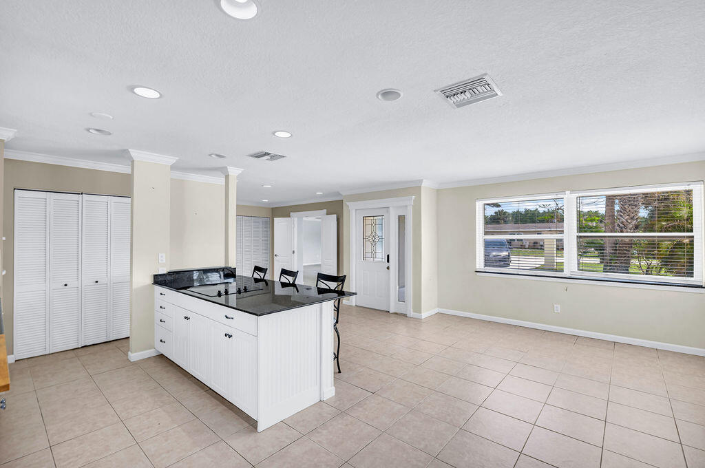 614 Southeast Flamingo Avenue Stuart, FL 34996 - Photo 14 of 49 a kitchen with stainless steel appliances a stove a sink and a refrigerator