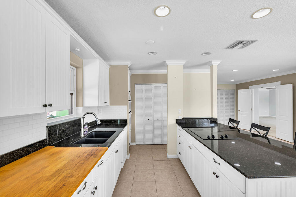 614 Southeast Flamingo Avenue Stuart, FL 34996 - Photo 15 of 49 a large white kitchen with a large window