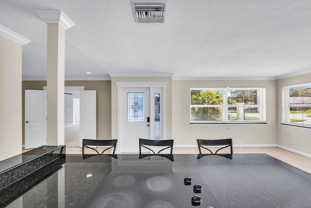 614 Southeast Flamingo Avenue Stuart, FL 34996 - Photo 17 of 49 a living room with furniture and a window