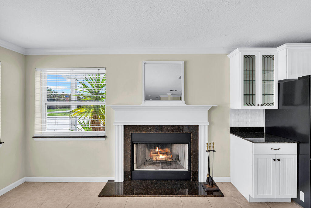 614 Southeast Flamingo Avenue Stuart, FL 34996 - Photo 21 of 49 a living room with furniture and a fireplace