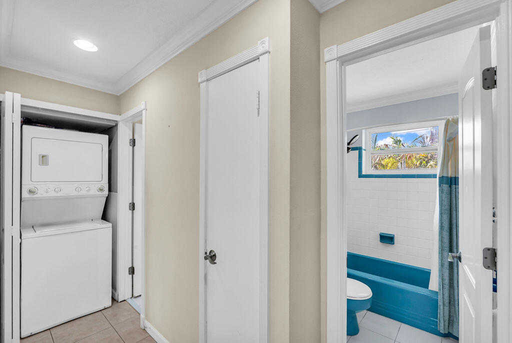 614 Southeast Flamingo Avenue Stuart, FL 34996 - Photo 30 of 49 a bathroom with a toilet sink and mirror