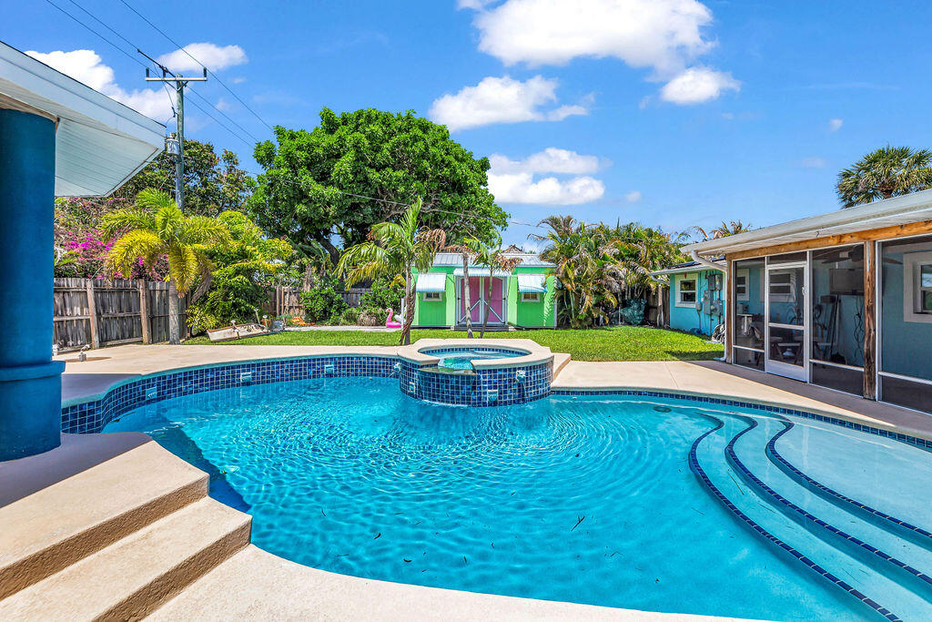 614 Southeast Flamingo Avenue Stuart, FL 34996 - Photo 3 of 49 a view of swimming pool with seating space and yard