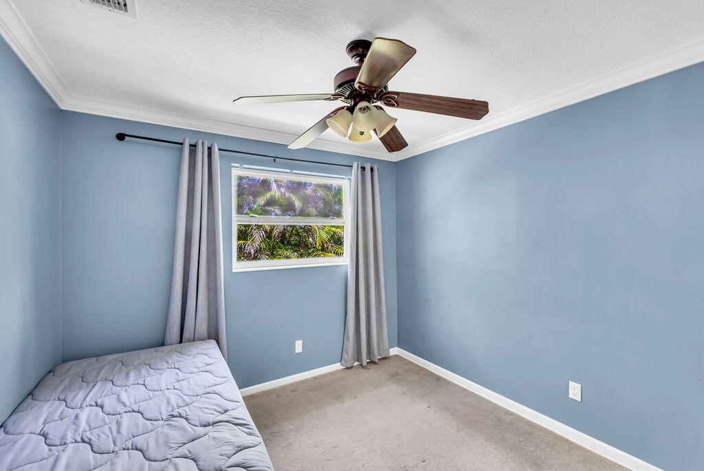 614 Southeast Flamingo Avenue Stuart, FL 34996 - Photo 34 of 49 a bedroom with a bed and a window