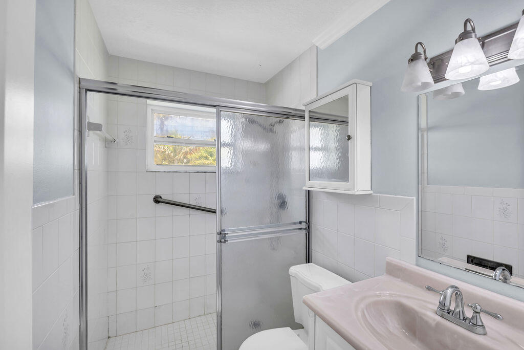 614 Southeast Flamingo Avenue Stuart, FL 34996 - Photo 36 of 49 a bathroom with a sink toilet and shower