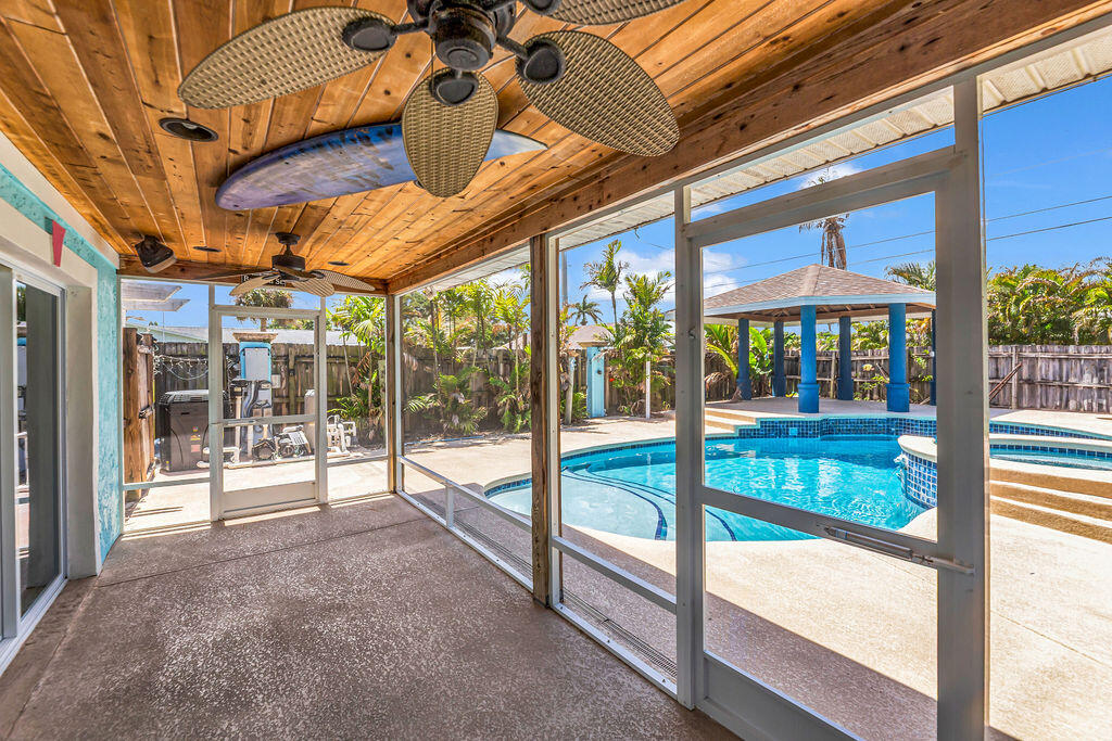 614 Southeast Flamingo Avenue Stuart, FL 34996 - Photo 40 of 49 a view of a porch with furniture and floor to ceiling window