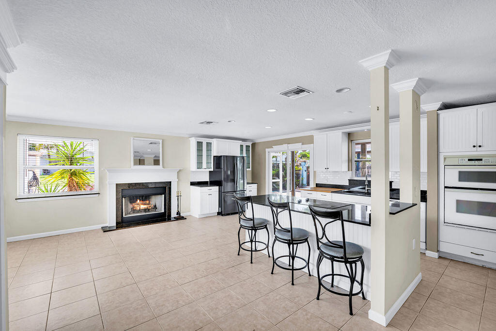 614 Southeast Flamingo Avenue Stuart, FL 34996 - Photo 4 of 49 a view of kitchen with furniture and fireplace