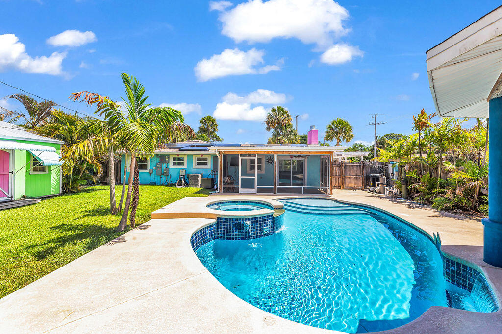 614 Southeast Flamingo Avenue Stuart, FL 34996 - Photo 45 of 49 a view of a swimming pool with a lounge chairs