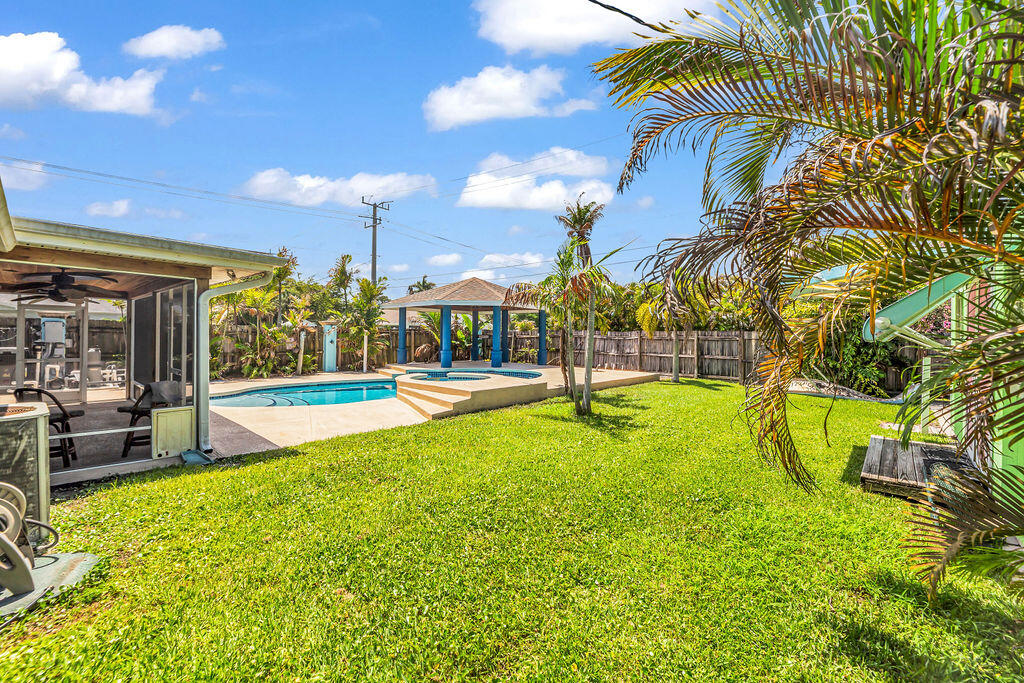 614 Southeast Flamingo Avenue Stuart, FL 34996 - Photo 47 of 49 a view of swimming pool with outdoor seating and yard