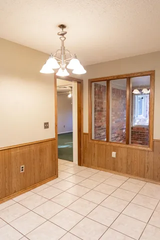 a bedroom with a large bed and a large window