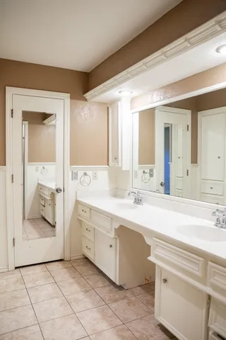 a spacious bathroom with a double vanity sink mirror and