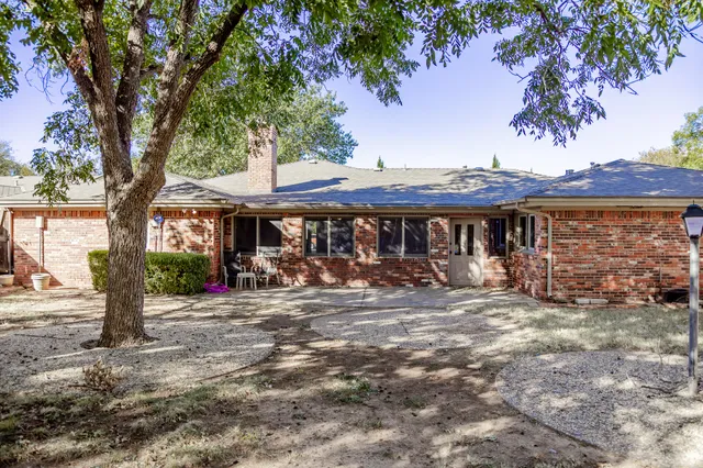 a front view of a house with yard patio and outdoor seating