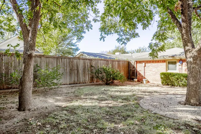 a view of a house with a tree in the background