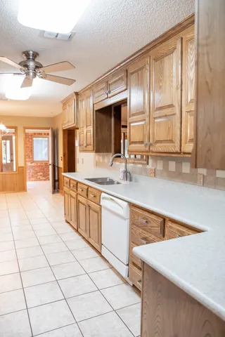 a large kitchen with kitchen island granite countertop a large counter top space appliances and cabinets
