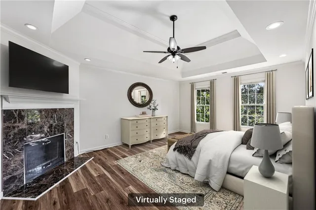 a bed room with a bed a television and fireplace