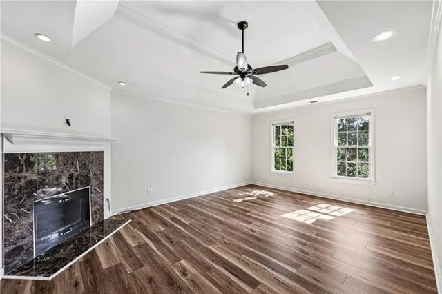 a view of an empty room with a fireplace and a window