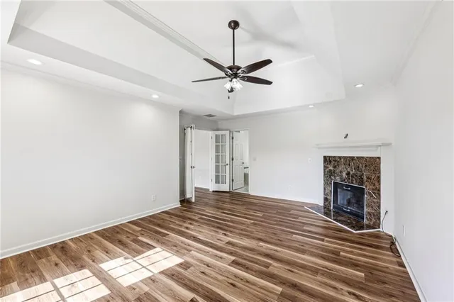a bedroom with a bed dresser and a chandelier