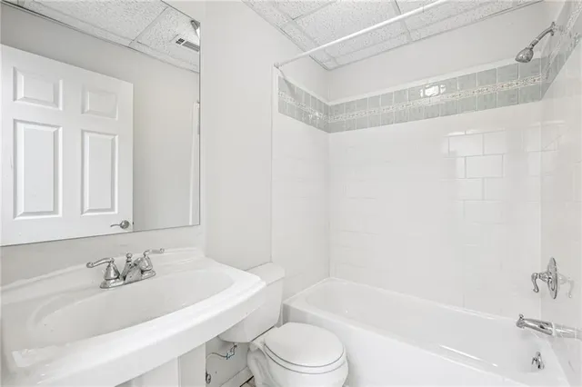a bathroom with a sink a toilet and a bathtub