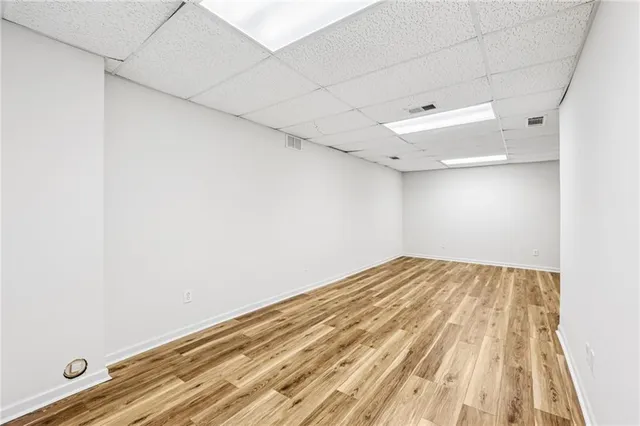 a view of empty room with wooden floor