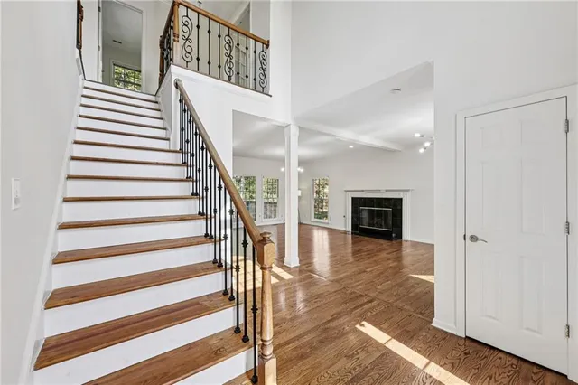 a view of entryway and hall with wooden floor