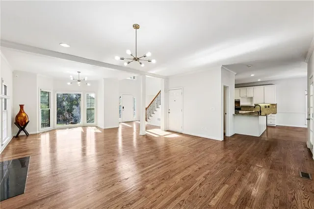 a view of empty room with wooden floor and fireplace