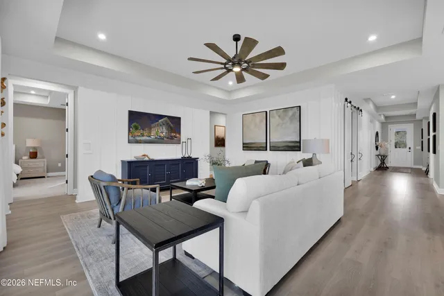 a spacious bedroom with a bed lamp and window