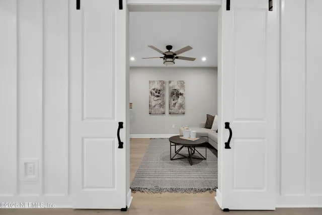 a living room with furniture and wooden floor