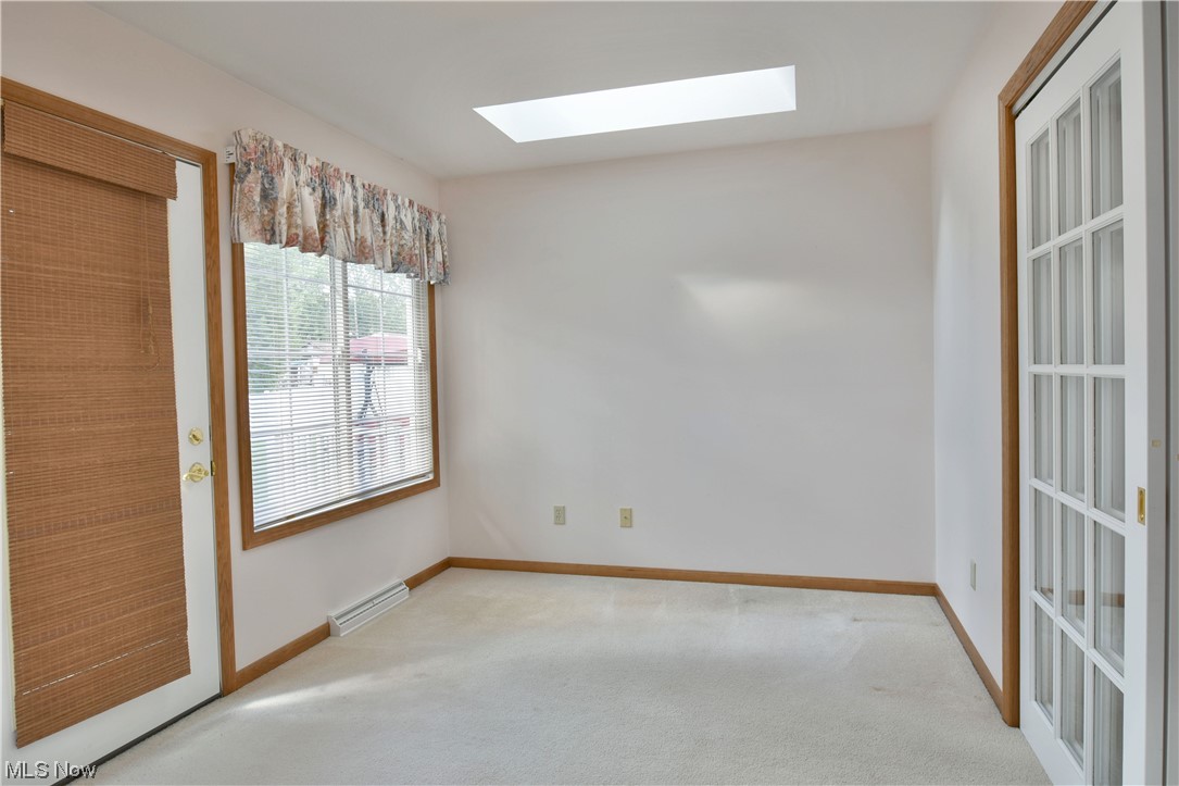2033 East River Road, Unit 11 Newton Falls, OH 44444 - Photo 16 of 35 Empty room featuring a baseboard radiator and light carpet
