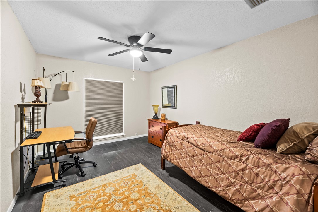 5213 Inverness Drive Corpus Christi, TX 78413 - Photo 12 of 23 a bedroom with bed and a chair