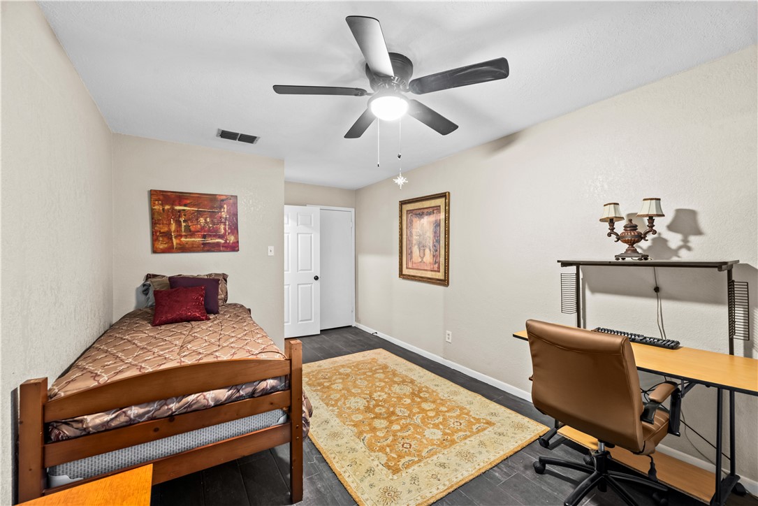 5213 Inverness Drive Corpus Christi, TX 78413 - Photo 13 of 23 a bedroom with a bed and a desk