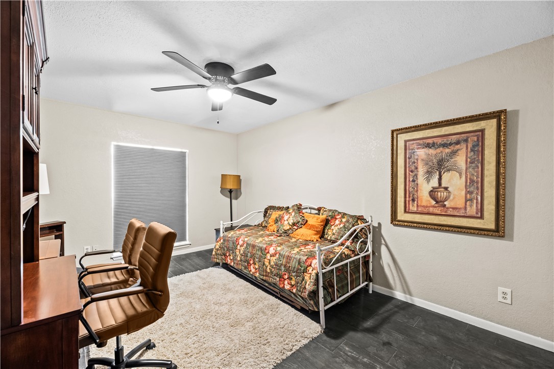 5213 Inverness Drive Corpus Christi, TX 78413 - Photo 14 of 23 a bedroom with a bed and a chandelier