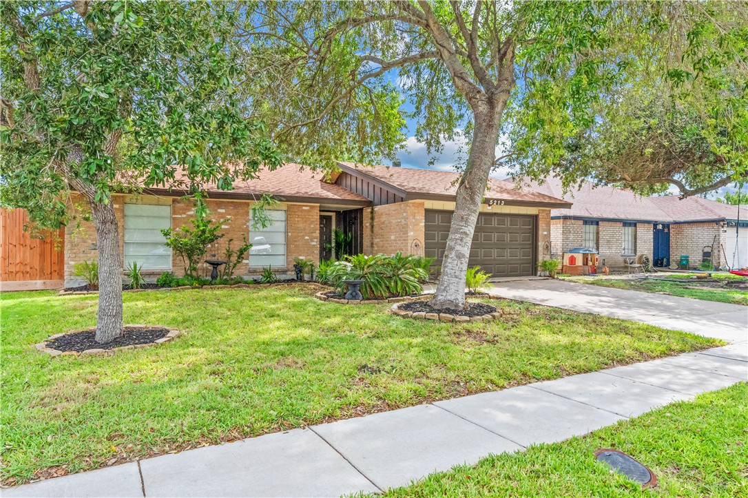 5213 Inverness Drive Corpus Christi, TX 78413 - Photo 2 of 23 a front view of a house with a yard